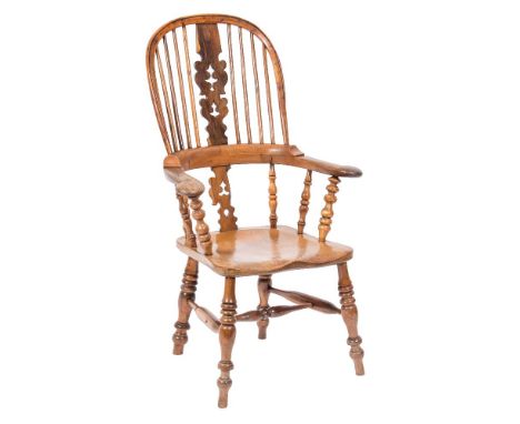 A Victorian elm and yew-wood stick back Windsor elbow chair:, the arched back with a shaped and pierced central splat, having