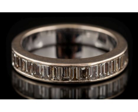 A baguette-cut diamond mounted half-eternity ring: the band channel-set with single row of baguette-cut diamonds estimated to