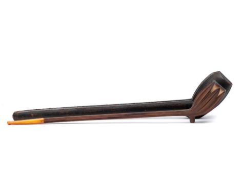 An unusual 19th century carved hardwood pipe: with elongated wood stem and amber mouthpiece,  stamped GBD, 38cm. long contain