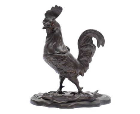 A late 19th century French bronze inkwell in the form of a cockerel: with inset glass eyes and hinged head, mounted on a natu