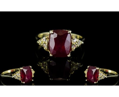 Ruby Solitaire and White Topaz Accents Ring, a 4.25ct elongated cushion cut ruby accented to either side by a triangle of thr