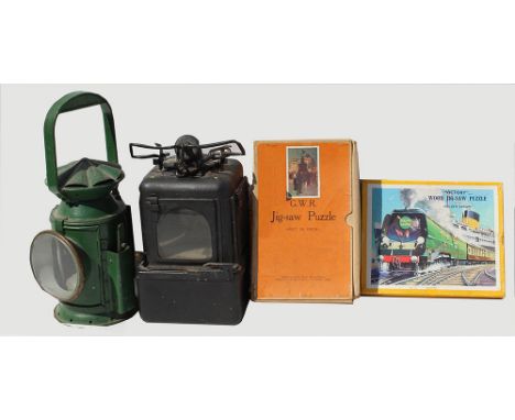 A WD Handlamp together with a Lamp Interior and a couple of un-made Jigsaws including GWR Piccadilly Circus and Victory Golde