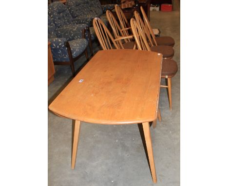 		Ercol furniture. A dropleaf light wood dining table and six stickback chairs