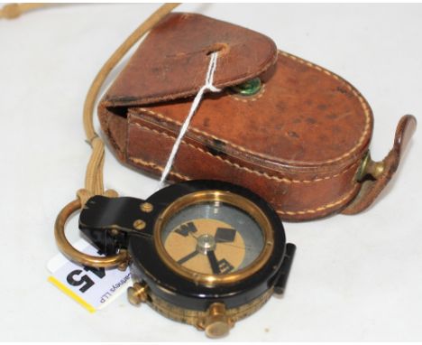 		A military marching compass in leather case