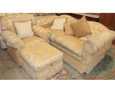 		A sofa, armchair and footstool upholstered in gold brocade