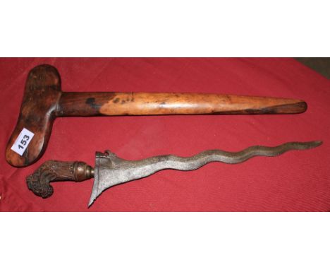 A Moro Kris sword, with undulating blade, carved wood handle and wood scabbard. 21 ½' long overall.