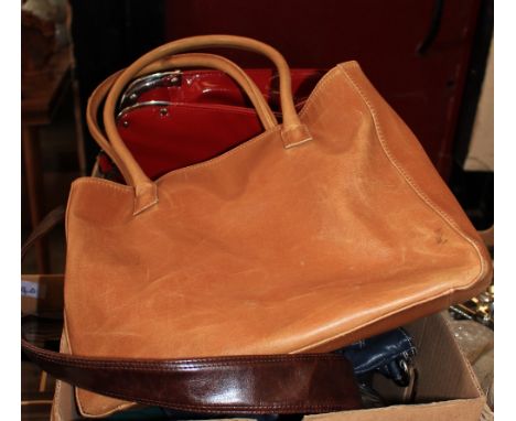 		A box of handbags, a box of kitchenalia, a box of dolls clothes and a picnic hamper