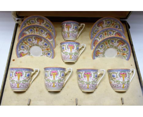 A set of six Royal Worcester coffee cups and saucers,  painted in colour with roses and a vase, printed mark,  date code for 
