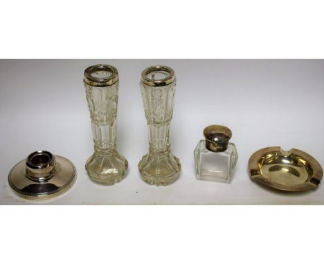 A George V smelling salts bottle, silver cover, faceted glass bottle, Chester 1911; a silver ashtray, Sheffield 1967; a silve