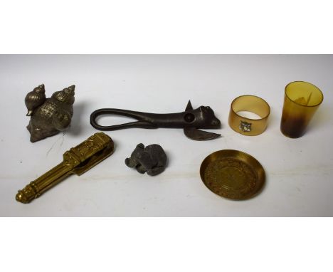 A cast metal Bully Beef tin opener; a horn napkin ring, silver shield; a lead elephant figure, etc
