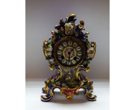 A late 19th century French Rococo mantel clock, with Roman numerals, on a bleu celeste ground, the centre with summer flowers