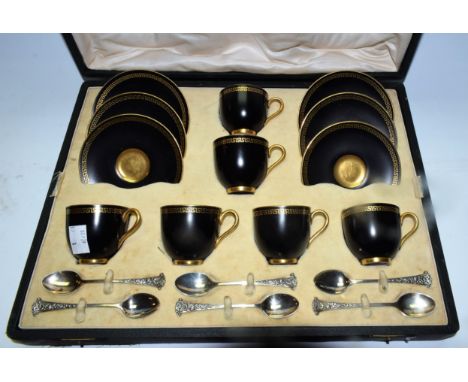 A set of six Royal Worcester demi tasse coffee cups and saucer with black background gilded with a greek key border in Art De
