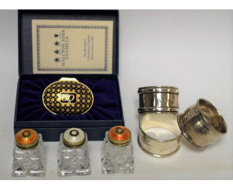A pair of Norwegian silver and orange guilloche enamel topped salt and pepper shakers, marked 925, 4.5cm high; another, singu