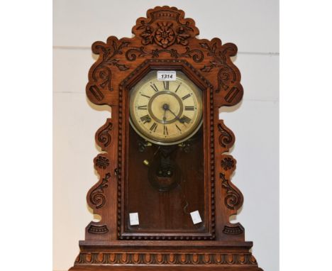 An Ansonia Clock Company gingerbread clock, twin winding holes, Roman numerals, 57cm high