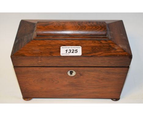 A mid 19th century rosewood sarcophagus shaped tea caddy standing on four bun feet with two interior lidded compartments, app