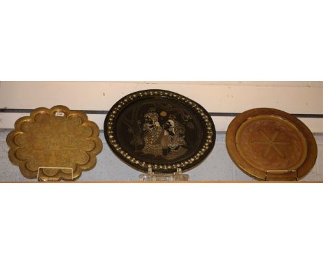 Tribal Art - a Persian/Ottoman style circular wall plaque, engraved with figures toasting beneath the moon; others brass (3)