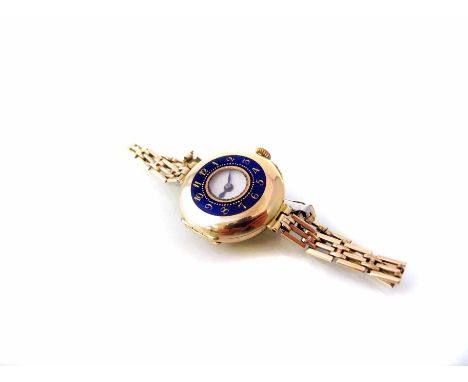 Lady's vintage 18ct gold early wristwatch on a rolled gold bracelet, early half-hunter style wristwatch with blue enamelled o