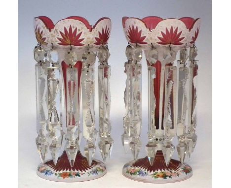 Pair of Victorian glass lustres, with ruby bodies overlaid in white, cut through, enamelled and gilded, each fitted with twel