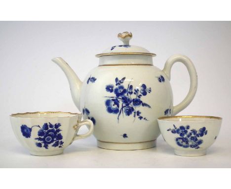 Worcester teapot, teabowl, and teacup circa 1775, painted with 'dry blue' flowers, hatched blue square mark to base of cup on
