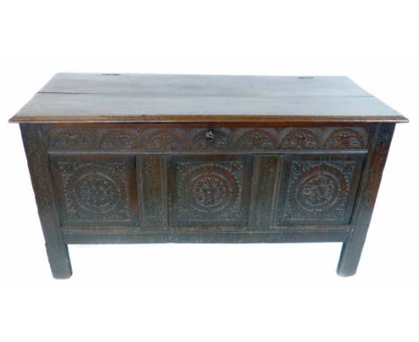 Early 17th century oak joint chest, two plank top with wire work hinges, three panel front carved with rosettes, interior wit
