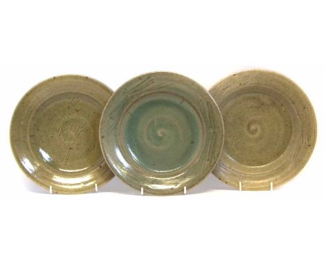 Jim Malone (b.1946) three plates, incised with a wavy lines and decorated with green glaze, incised J.M. to bases, (3) 25cm d