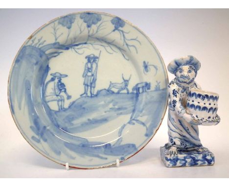 Delft plate, painted with figures in a landscape on playing a pipe, mid 18th century, also a Dutch delft mid-19th century mon