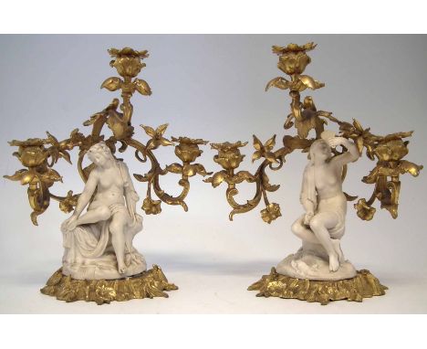 Pair of Parian and Ormolu mounted candelabra figures, each modelled as a semi - nude female sat on rocky base within elaborat