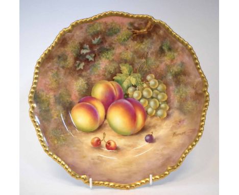 Royal Worcester plate signed Freeman, painted with fallen fruit within gilt gadrooned border, black printed mark to reverse, 