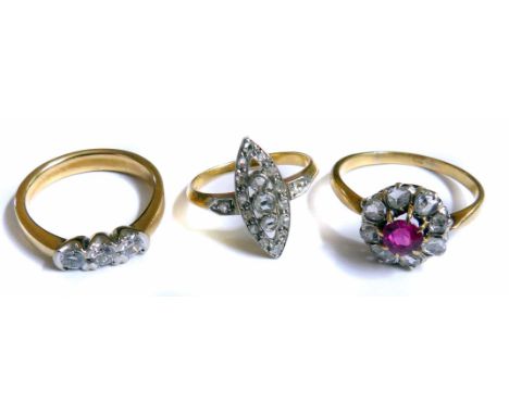 Three diamond set rings including a ruby and diamond round cluster yellow gold ring, central round mix cut ruby approximately