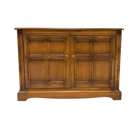 Ercol - hi fi cabinet, with hinged lifting lid over two cupboard doors