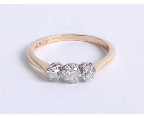 An 18ct diamond and platinum three stone ring, set with old cut diamonds, size K.