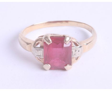 A ruby style and diamond set ring in yellow gold, unmarked, size L.