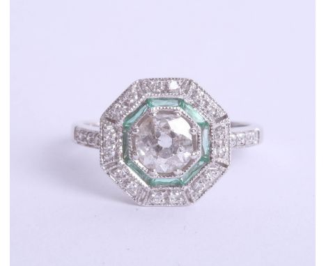 An art deco style diamond and emerald ring set in 18ct white gold, approx 0.95ct, Size M.