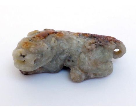 A Chinese jade carved figure of recumbent auspicious beast, brown surface on the back of the beast. Later Ming/ Earlier Qing 