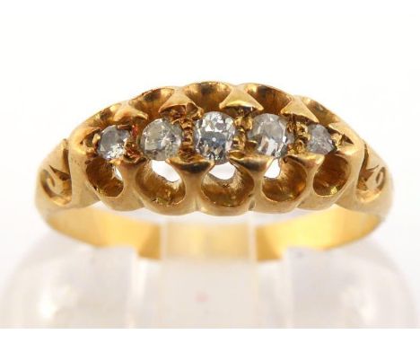 A five stone diamond ring, set with small graduating old brilliant cuts, claw set to scroll work shoulders, mounted in yellow