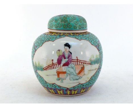 A Chinese famille rose tea jar with original seal lid, decorated with two panels of figures on turquoise ground. Iron red mar