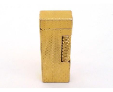 Dunhill, a gilt metal lighter, with rectangular engine turned body, 6.4cm long 