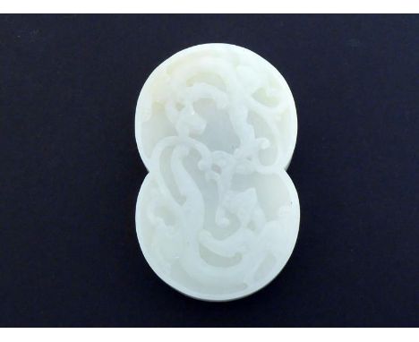 A Chinese carved white jade buckle of figure-of-eight form, carved with two Chi dragons on the top, one of the fittings to re