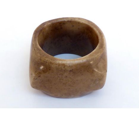 A Chinese archaic style carved jade “Cong”, brown surface with occasional cream colour, 19th century, 7cm wide and 4cm high, 