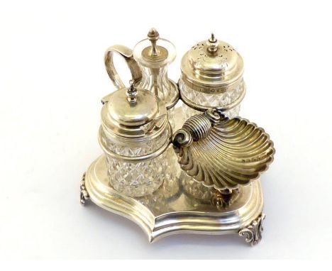A Victorian silver cruet by George Unite, Birmingham, 1873, the stepped escutcheon-form base on three scroll and leaf feet, t