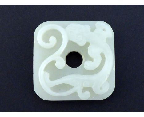 A Chinese white jade plaque in the form of a square “Bi”, the top carved in relief with scrolling Chi dragon, reverse carved 