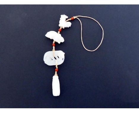 A group of four Chinese carved white jade attachments, one in form of a cockerel, one of a mouse, one of a pair of playful li