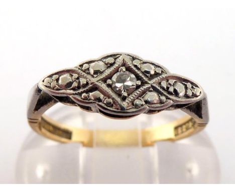 An Art Deco diamond plaque ring, the shaped platinum plaque with a small single-cut to the centre, the shank stamped '18CT PL