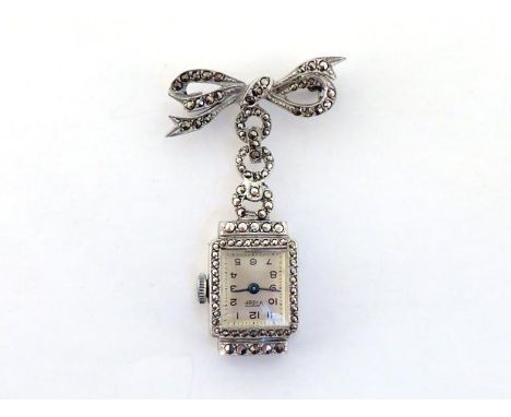A stainless steel and marcasite lapel watch, set with a Vidar manual wind movement, pave set with marcasite overall, to a bow