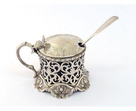 A Victorian silver mustard pot by George Angell, London, 1856, the scroll-pierced circular body on six scroll-edged feet, eac
