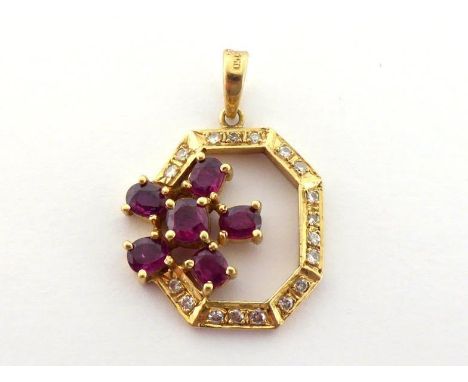 An 18 carat gold, ruby and diamond pendant, the openwork octagonal frame set to the top with a flower cluster of rubies, 18mm