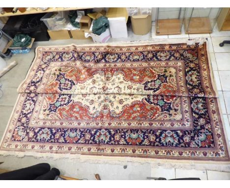 A Qum silk carpet in excellent condition decorated with floral motifs and patterns in the traditional manner. Approx 4x3 metr