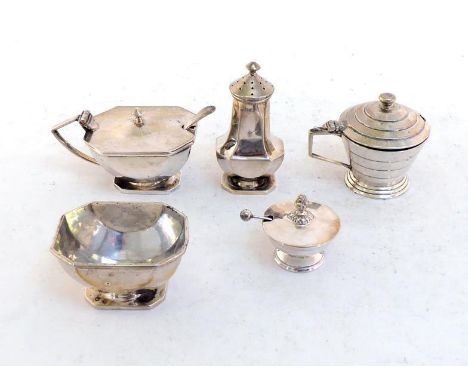 A silver three-piece condiment set by Ernest W. Haywood, Birmingham, 1934, oblong with cut corners and "C" shaped panels to s