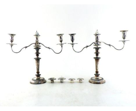 A pair of composite Old Sheffield Plate candelabra comprising a pair of candlesticks, circa 1815, together with a pair of ass