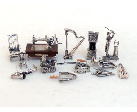 A group of modern Italian silver toys, mostly stamped ".925", the sewing machine stamped ".800", comprising:- a flat iron and